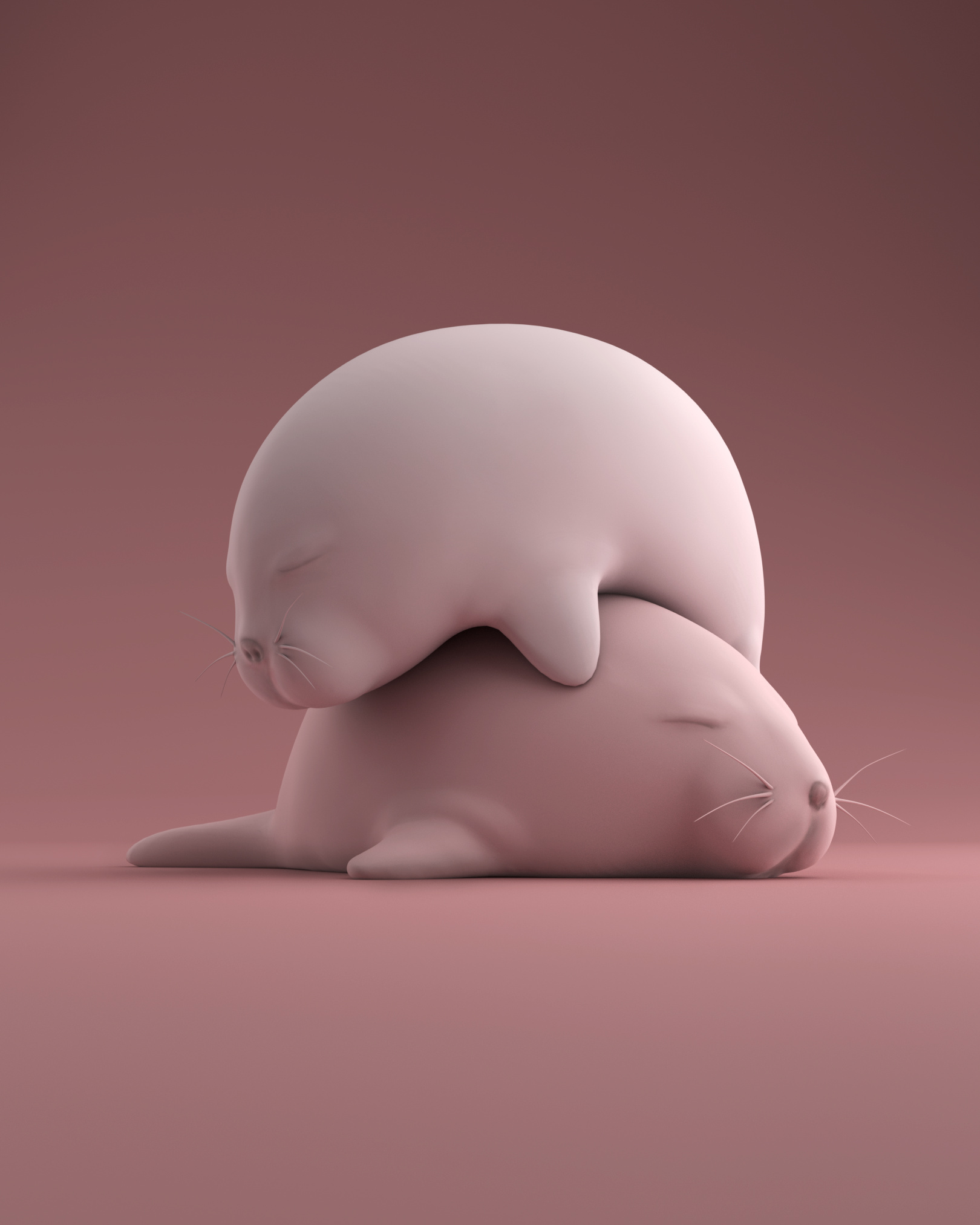 2 Gray seals atop each other in pinkish lighting